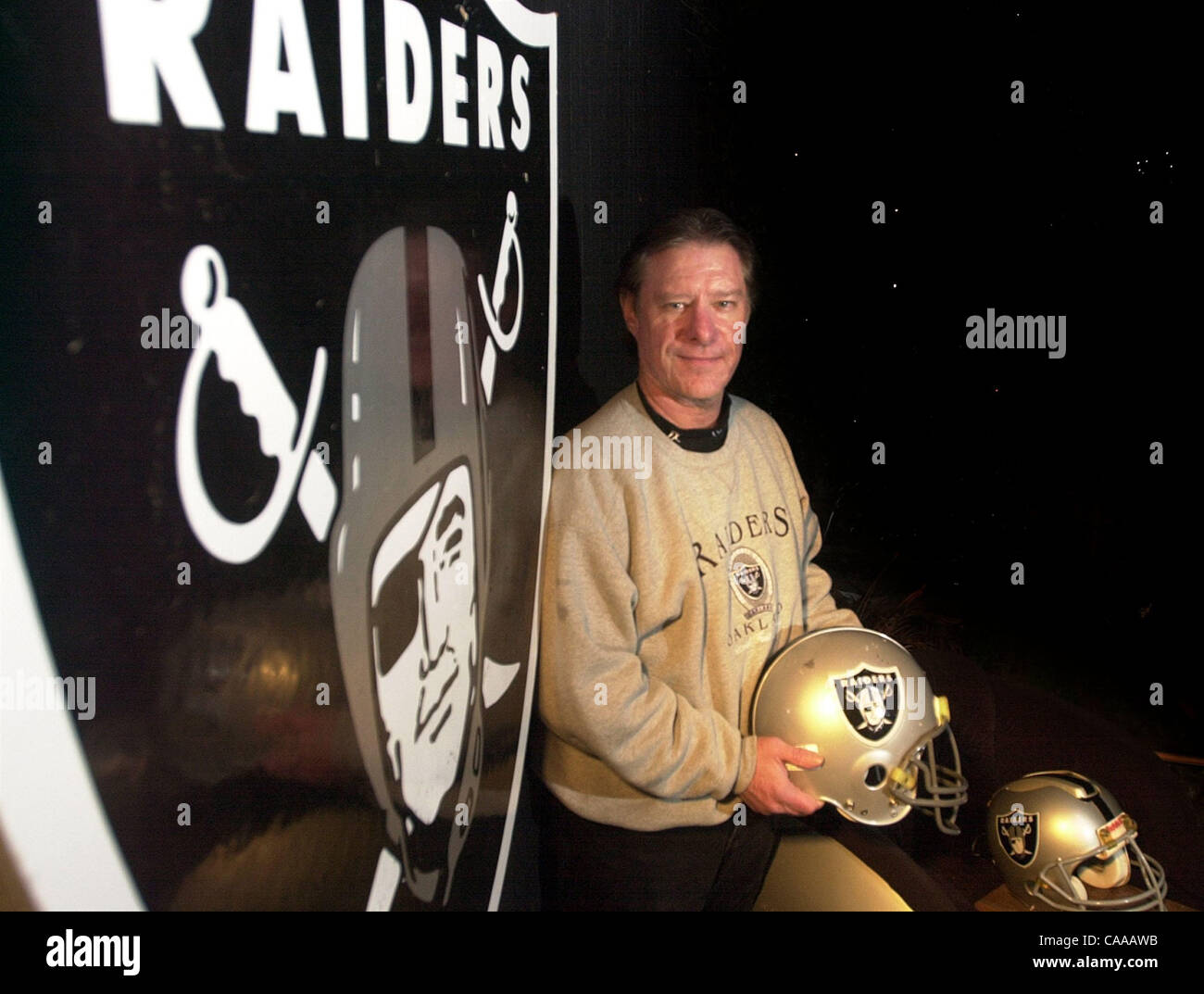 Richard Oliver,who is a big Oakland Raiders fan, stands on his patio with some of his Raiders