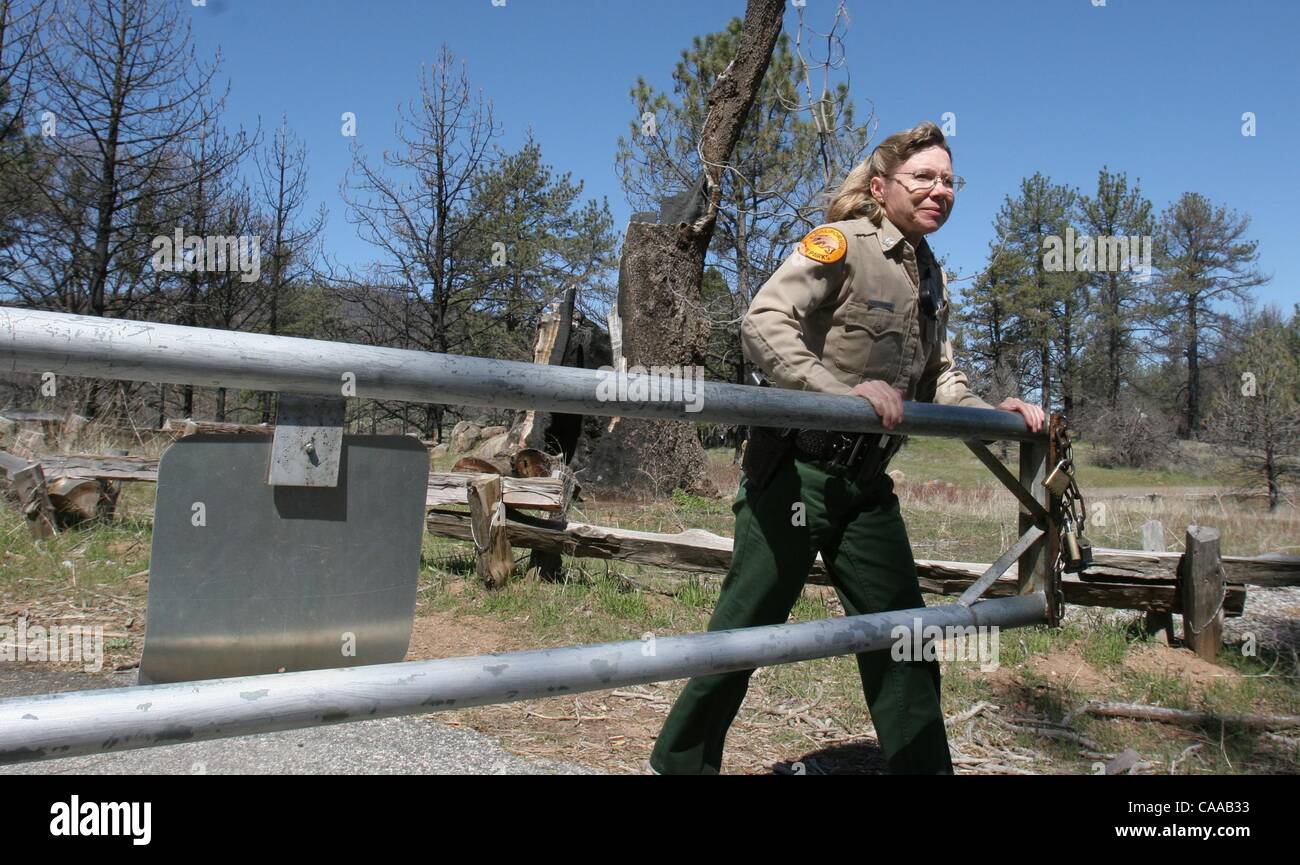 (Published 3/31/2005, B-1:1,2,7, B-2:6)  Laura Itogawa, head ranger at Rancho Cuyamaca State Park opens a gate to a road in the park.  The park, will open to reservations on the first of April.  UT/John Gastaldo Stock Photo