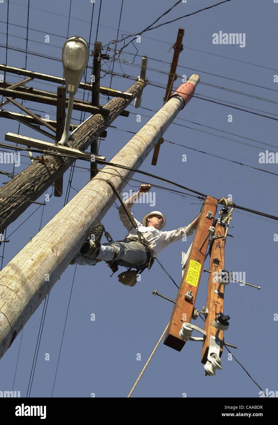 Garrett Maddex a lineman for a PG&E general construction crew strings ...