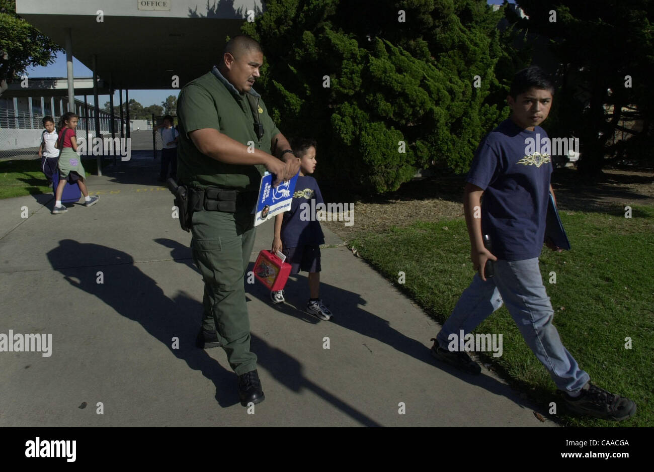 Published 01/31/2003, B-4:1) Augustine Hernandez, left, escorts his sons  Daniel Antonio Hernandez, 5, and Augustine Jaime Hernandez, right, home  from school at Lilian Rice School in Chula Vista, the site of a