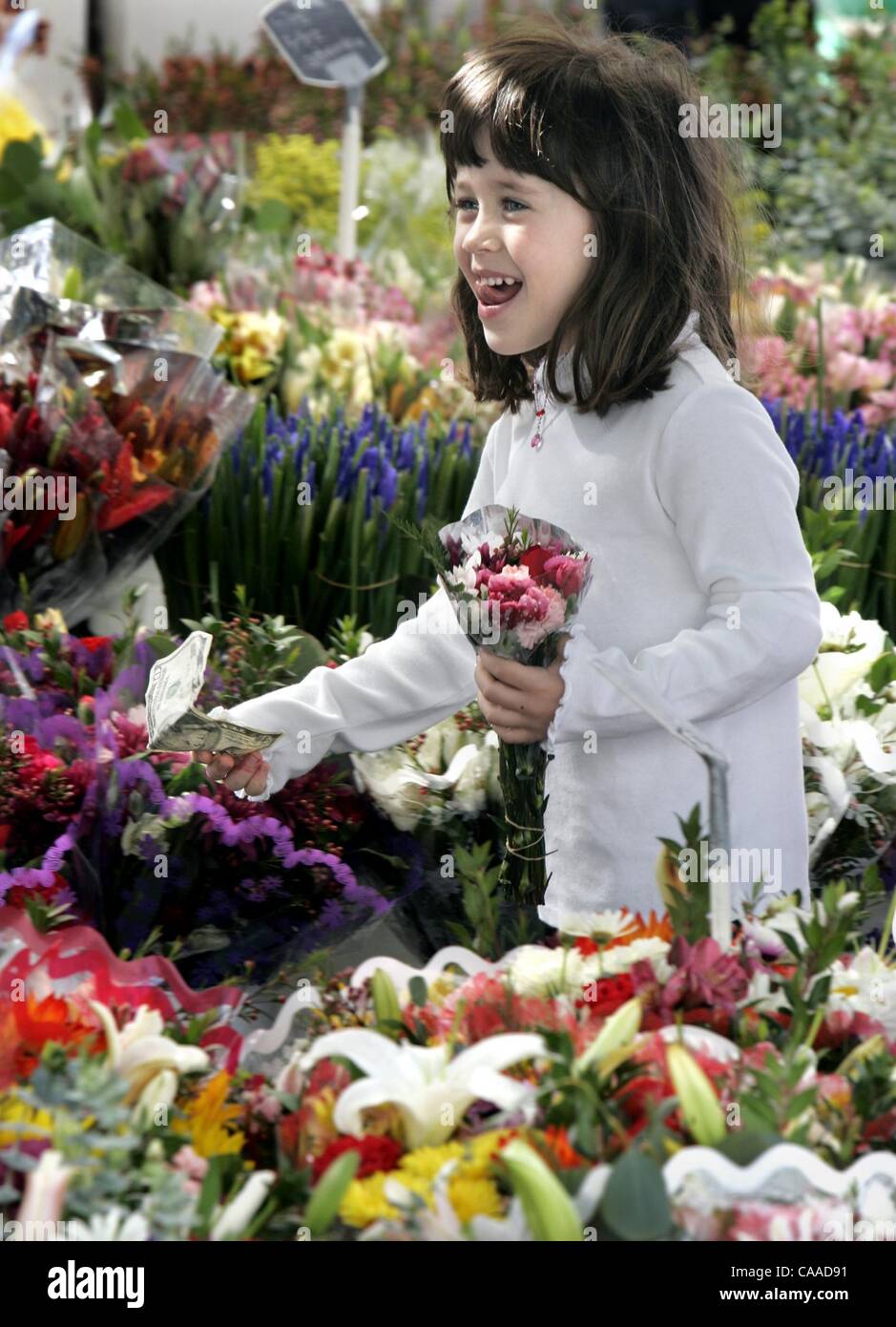 (Published 02/14/2005, B-3)SLflowers235221x001/Feb 13---Four-year-old Jenna Otaola (cq) from Tierrasanta ran to pay for her Valentine bouquet she purchased for her mother at Hidalgo Flowers booth at the Hillcrest Farmers Market.  Otaloa was shopping with her grandparents when she spotted the perfect Stock Photo