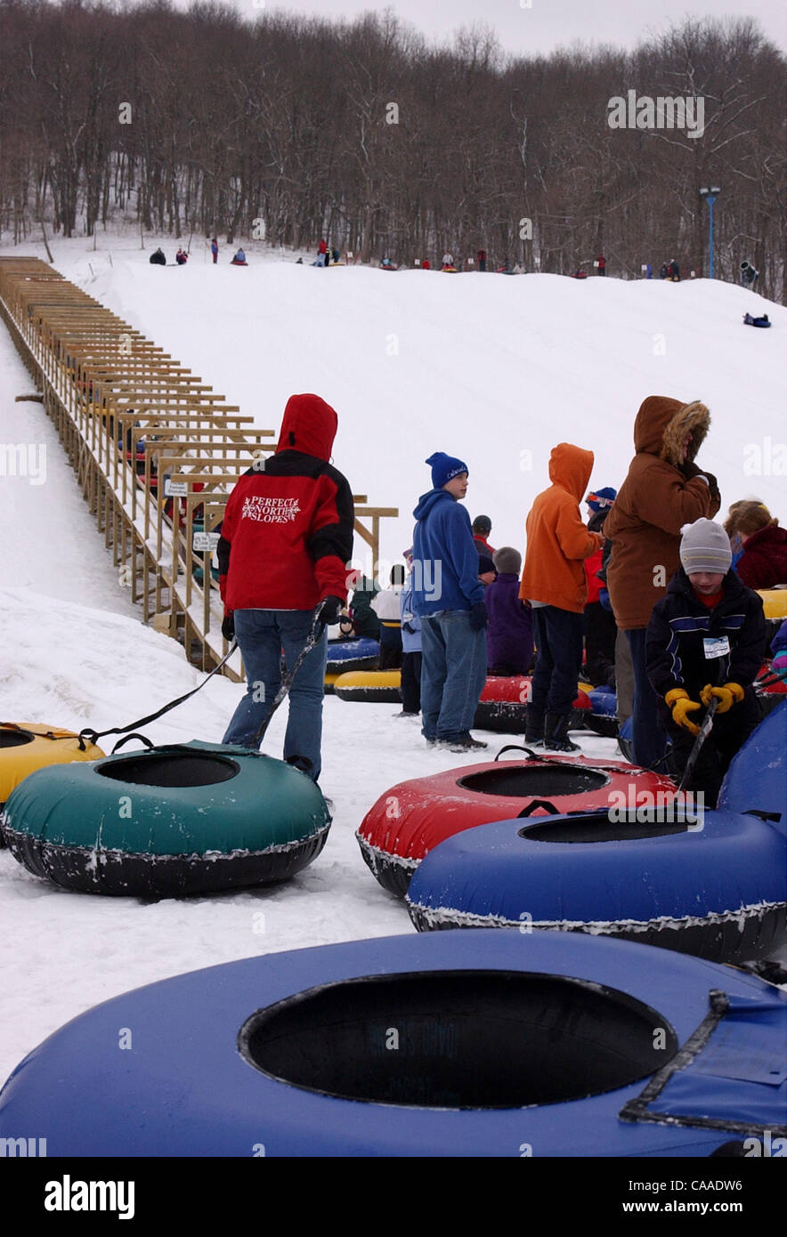 Feb 18, 2003 - Lawrenceburg, Indiana, USA - Patrons of  Perfect North Slopes Ski Resort  having a day of fun SNOW TUBING on a 600 foot hill, covered with a four foot base of man made snow. (Credit Image: © Ken Stewart/ZUMA Press) Stock Photo