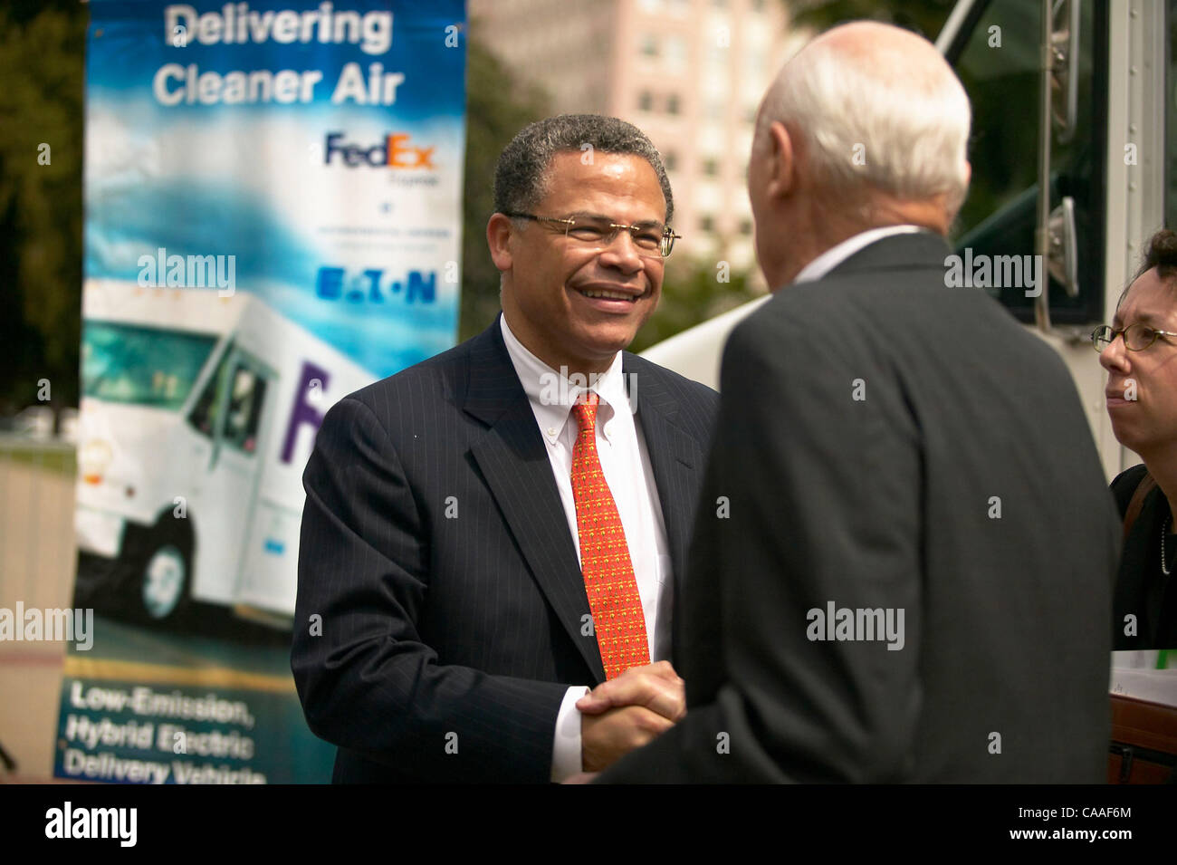 Mar 31, 2003; Sacramento, CA, USA; Eaton Corporation's Senior Vice President Jim Sweetnam talks with person at   Environmental Defense, FedEx Express, and Eaton Corporation unveil new hybrid delivery trucks that emit 90% fewer emissions and go 50% further on a gallon of gas Stock Photo