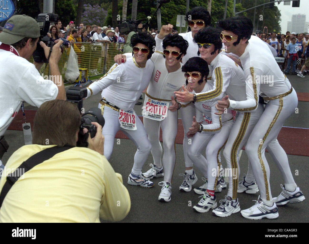 (Published 06/02/2003, E-16) Runners dressed like Elvis pose for a picture befoire the start of the Suzuki Rock n Roll Marathon on Sunday morning. UT photo by Eduardo Contreras Stock Photo