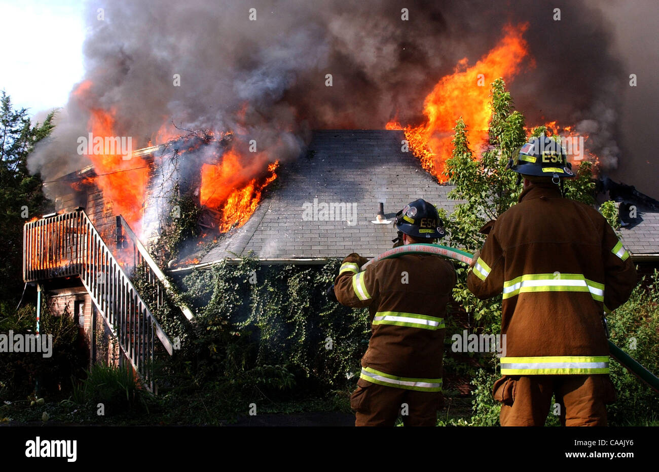 Sep 06, 2003 - Cincinnati, Ohio, USA - Firefighters burned the former Green Gables Motel at 4220 Harrison Ave as a training exercise. Pictured: Green Township Firefighters MIKE JOSEPH and JASON EDWARDS standby with hoses as the fire burns through the motel roof.   (Credit Image: © Ken Stewart/ZUMA P Stock Photo