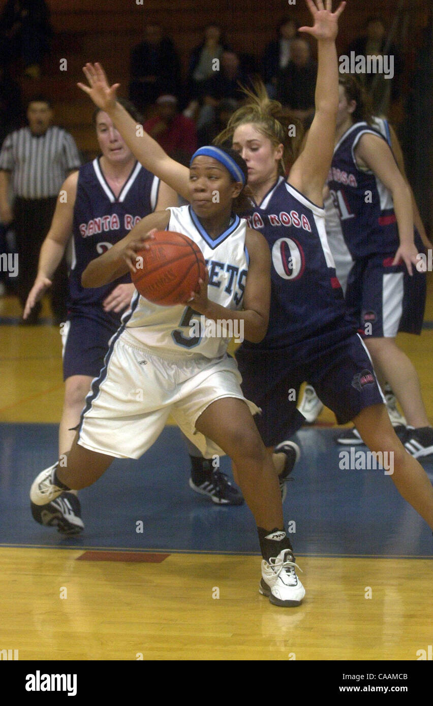Contra Costa College's Takara Todd (cq #5) works around the defense of Santa Rosa's Brooke Fraser (cq #20) in the first half of the game in San Pablo, Calif. Tuesday night, Jan. 20, 2004. (Contra Costa Newspapers/Joanna Jhanda)2004 Stock Photo