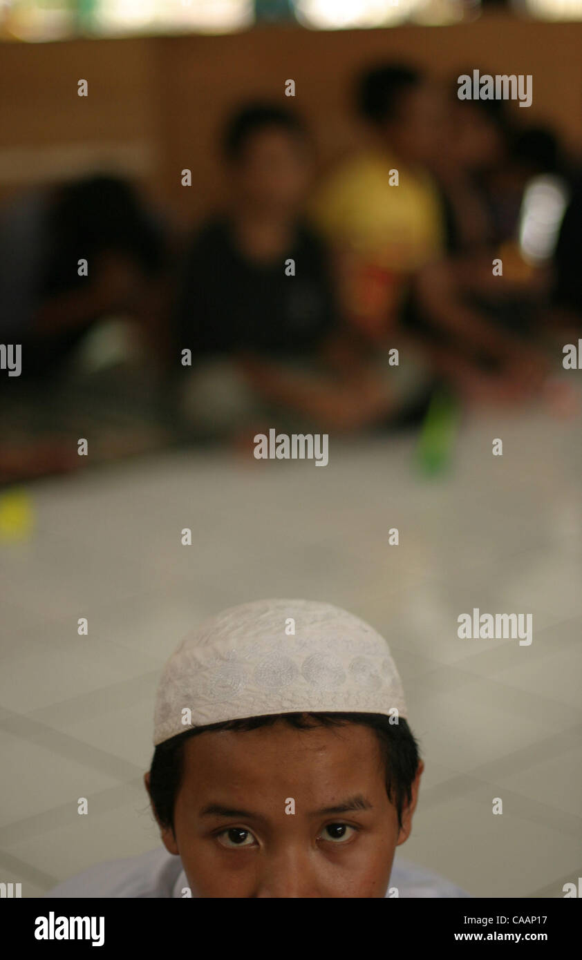BANDUNG, WEST JAVA, INDONESIA - DECEMBER 14, 2003 Wearing a traditional ...