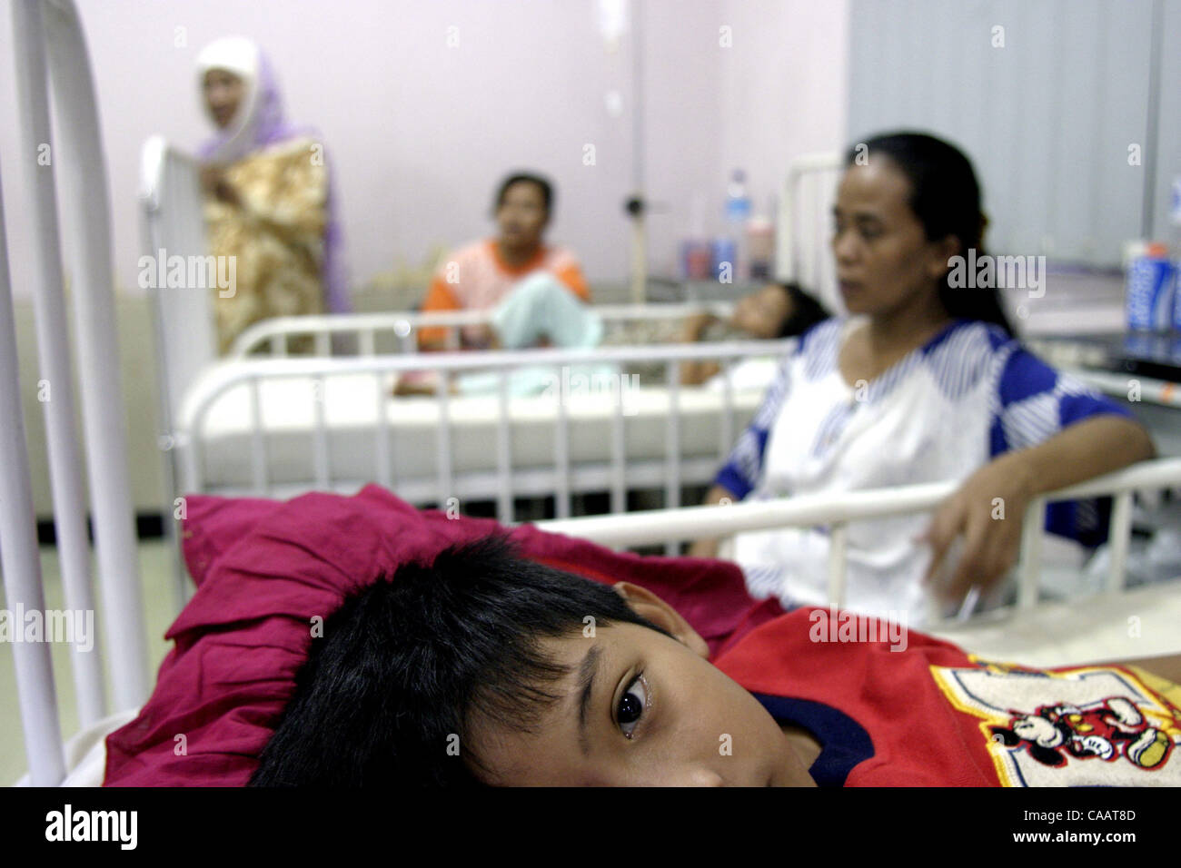 FEBRUARY 24,2004  JAKARTA, INDONESIA    A patient of DENGUE HAEMORRHAGIC FEVER  lies on the bed  at the Tarakan West Jakarta District Hospital.      Photo by Deny/JiwaFoto Stock Photo