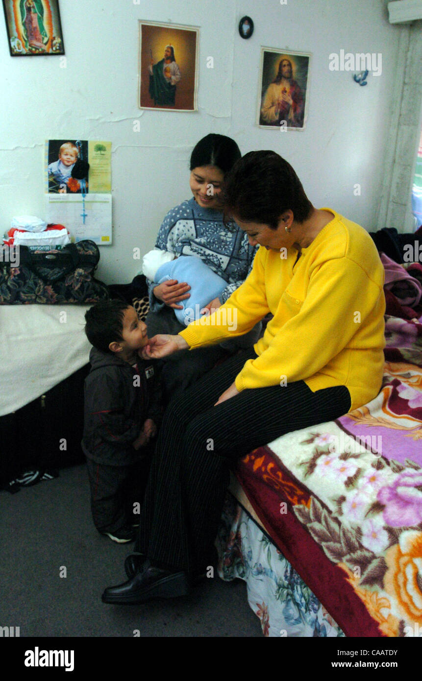 Rose Marie Wallace, right, a social worker with the Welcome Home Baby program, helps Obdulia Cruz Jan. 27, 2004, with her children Carlos Vazquez, 2, and Erik Vazquez, newborn, in their home in Concord, Calif.      (Bob Pepping/Contra Costa Times) Stock Photo