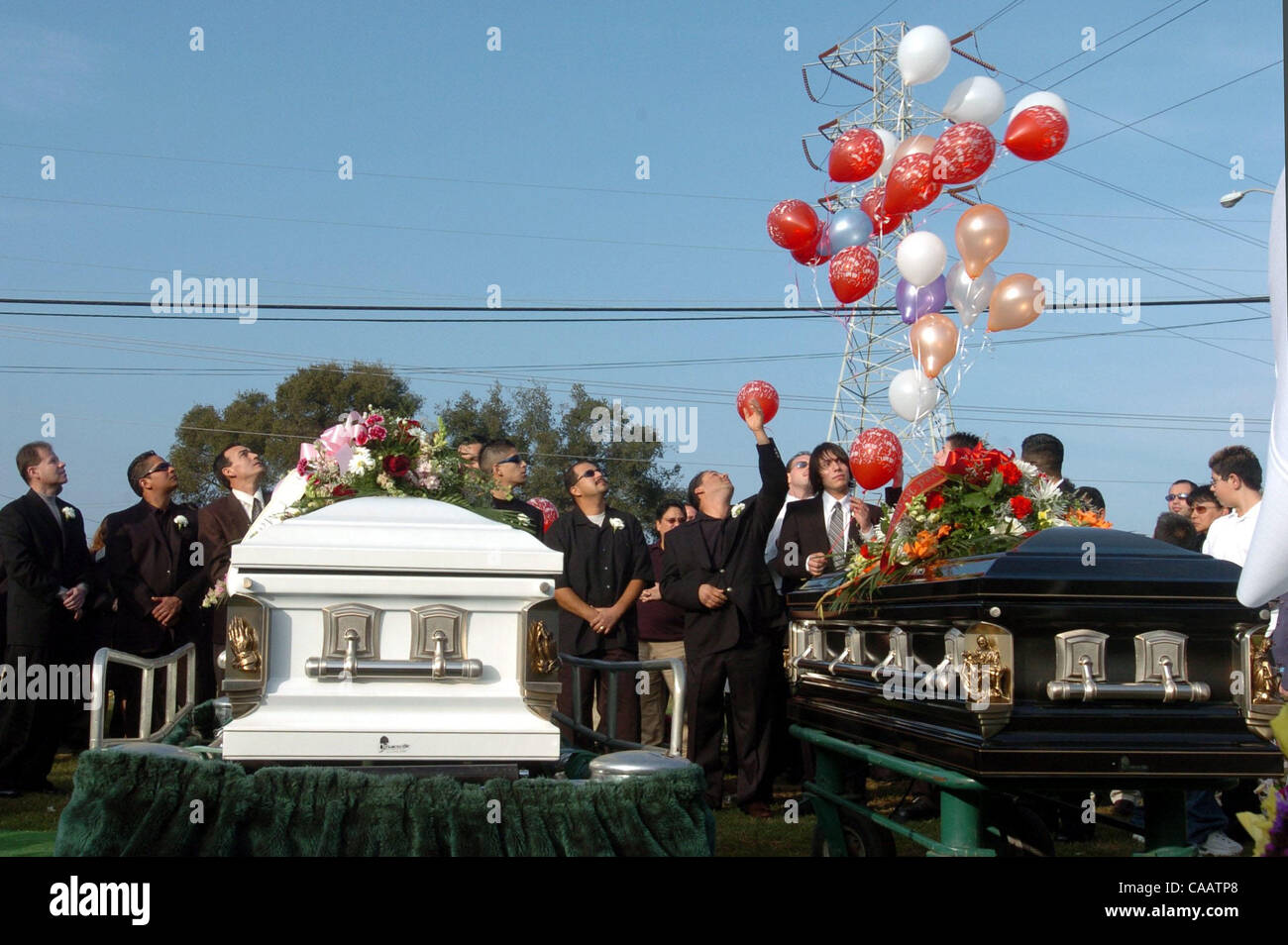 Family and friends release balloons during funeral services for Mary Helen Armstrong and her son Christopher Armstrong at Holy Cross Cemetery in Pittsburg, Calif. on Thursday, January 29, 2004. Mary, Christopher and Mary's husband Gary were found dead in their Antioch home.  (Dean Coppola/Contra Cos Stock Photo