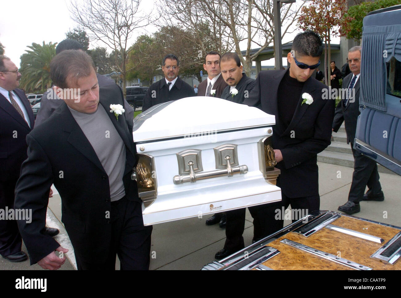 Family members including Manuel Pastor cq (left) Mary's nephew, of Orange County, and Mark Silva cq (right) Mary's godson, of Brentwood, load Mary Helen Armstrong's casket following  funeral services for Mary and her son Christopher at Church of the Good Shepard in Pittsburg, Calif. on Thursday, Jan Stock Photo