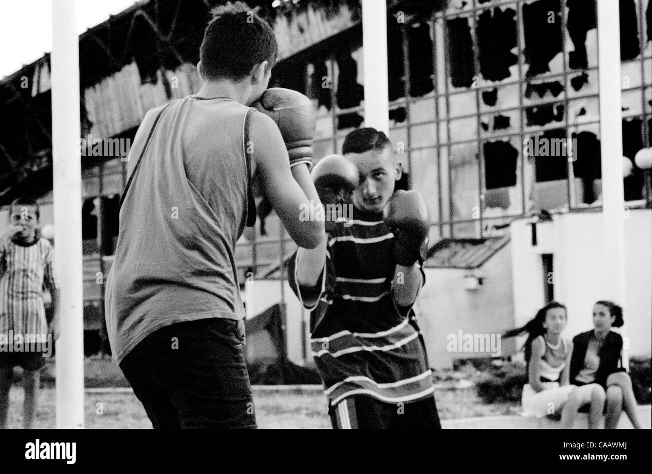 The boxing club practices outside the destroyed sports complex in Pristina, Kosovo. Stock Photo