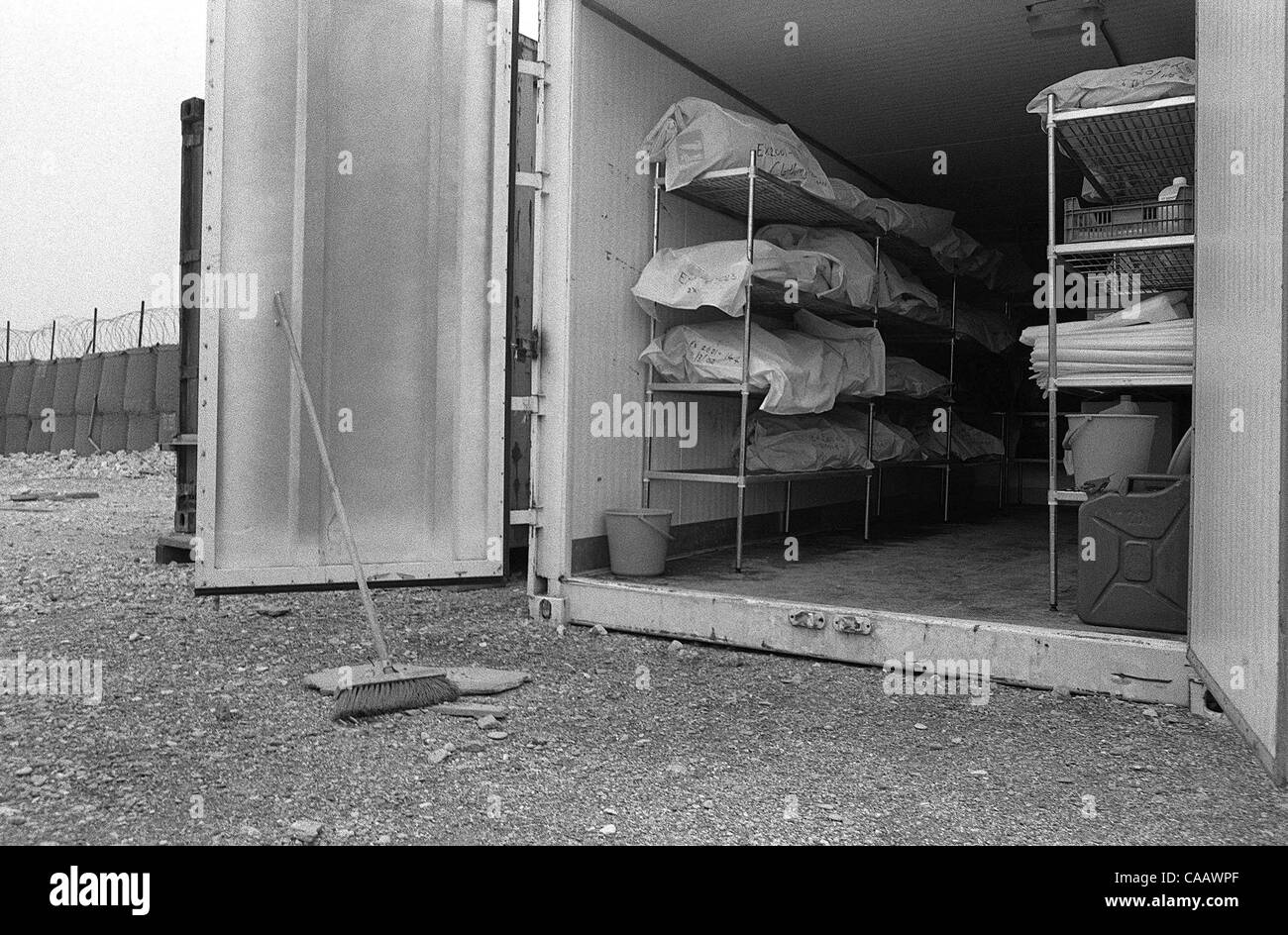 Bodies awaiting identification or reburial are stored in white body bags and cardboard boxes in refrigerated storage containers in Pristina, Kosovo Stock Photo