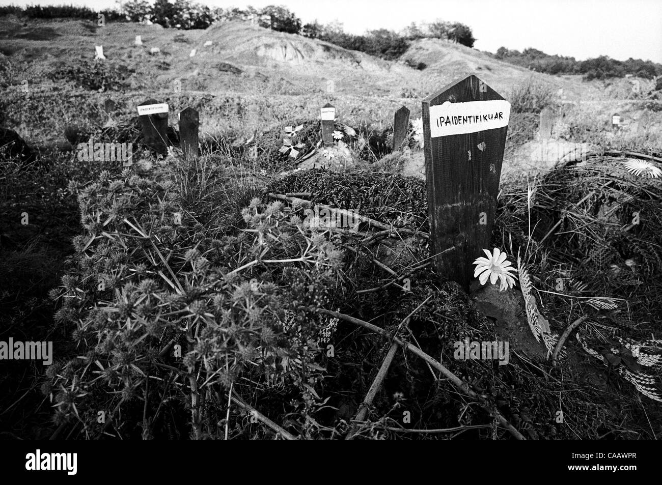 In the graveyard at Krushe e Mahde, Kosovo, many graves are simply marked, 'unidentified.' More than fifty bodies found after the war in 1999 were too badly burned to be identified. Stock Photo