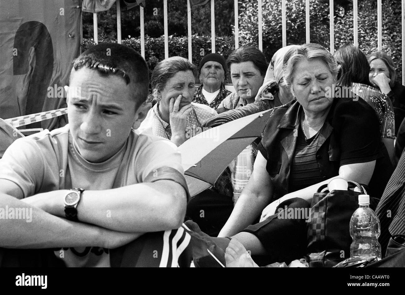 Albanian families of the missing sit in protest outside the parliament building in Pristina, Kosovo. They are upset with the lack of progress, and lack of communication with the investigators. Stock Photo