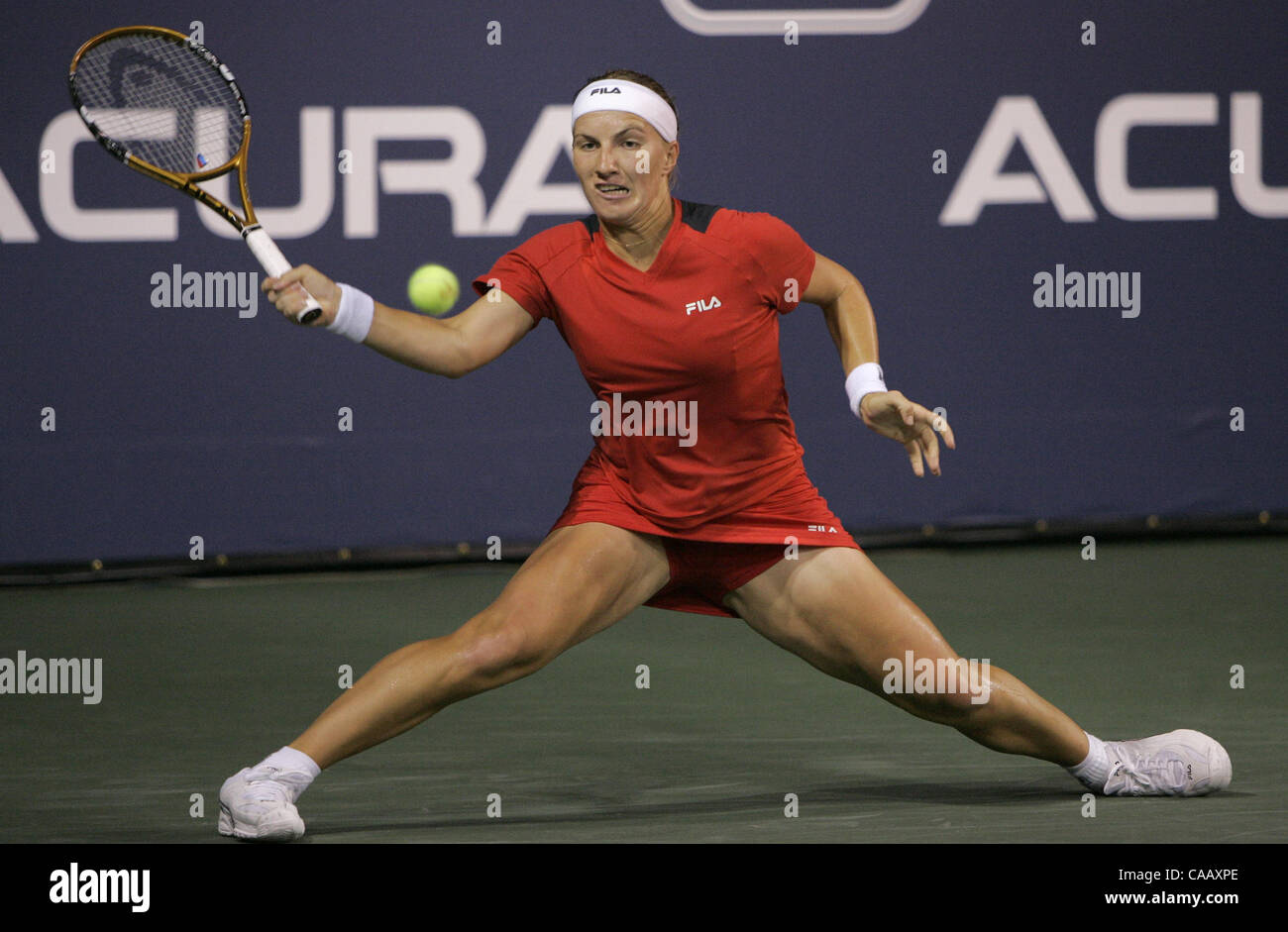 SVETLANA KUZNETSOVA, of Russia, slides while returning a shot during a long volley in her evening match against Klara Koukalova (CZE).  U/T photo CHARLIE NEUMAN Stock Photo