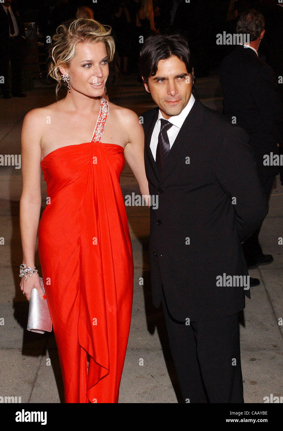 Feb 29, 2004; Los Angeles, CA, USA; Actor JOHN STAMOS and wife, actress REBECCA ROMIJN, arrive at the 2004 Vanity Fair Oscar Party at Morton's in West Hollywood. Stock Photo