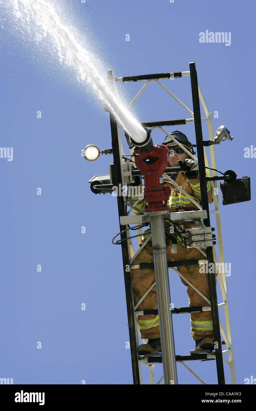 Published 9/3/2005, B-1:2; NC-1, NI-1) Firefighter JOHN SADO controls the  high pressure water hose on top of the fully extended 75 foot ladder truck  at the San Pasqual Fire Dept. U/T photo