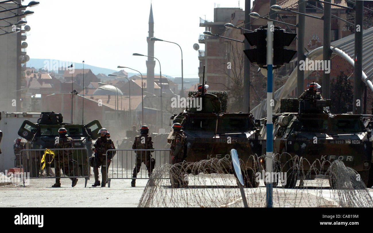 Mar 22, 2004; Kosovo, SERBIA; UN and NATO peacekeepers barricade the bridge which divides the troubled city of Kosovska Mitrovica into North (controlled by Serbs) and South (controlled by Albanians). The bridge is blocked with KFOR troops and armoured vehicles to prevent both sides from crossing the Stock Photo