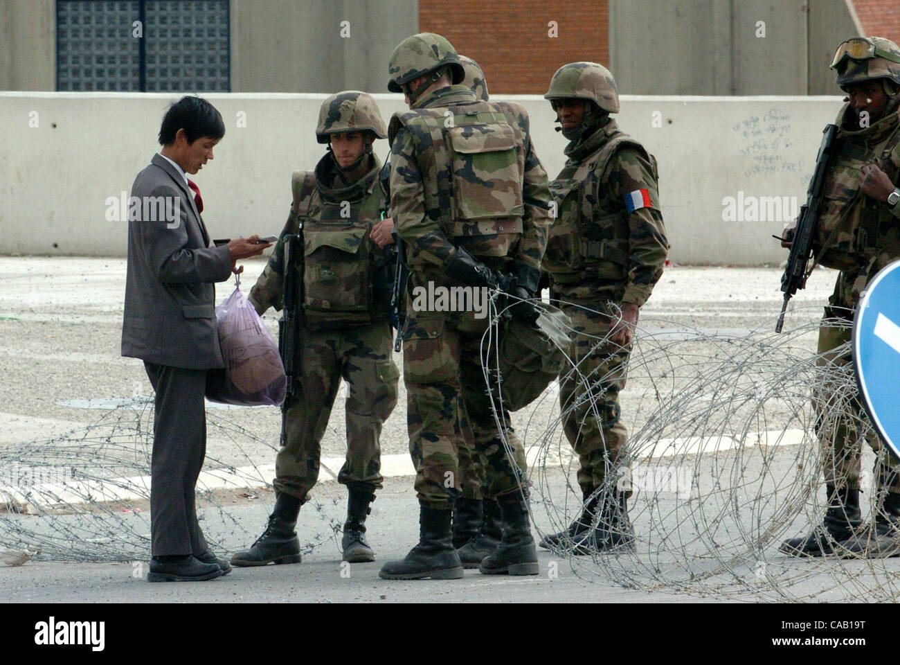Mar 22, 2004; Kosovo, SERBIA; French soldiers, part of NATO-led peacekeepers in Kosovo (KFOR), checking a person that wants to cross the bridge in Kosovska Mitrovica, near the bridge that divides this troubled city into North (controlled by Serbs) and South (controlled by Albanians). The bridge is b Stock Photo