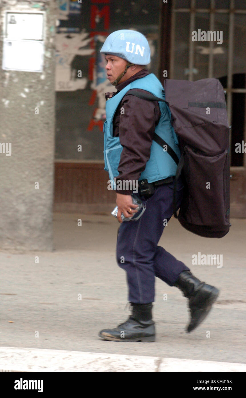Mar 22, 2004; Kosovo, SERBIA; A member of the UN carries a bag across the bridge over the Ibar River. Evacuation of UN personnel from the South part of Kosovska Mitrovica to the Northern part is in effect due to the increase of violence in the Kosovo region. UN and NATO peacekeepers barricade the br Stock Photo