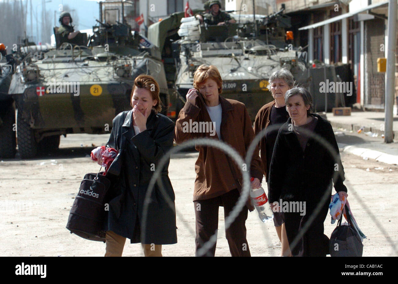 Mar 22, 2004; Kosovo, SERBIA; A Serbian women cries while leaving her home. Her family was expelled from their home by ethnic Albanians. KFOR soldiers escort them to the closest refugee center in Kosovska Mitrovica. The worst ethnic violence since the 1998-1999 Kosovo war erupted here and spread to  Stock Photo
