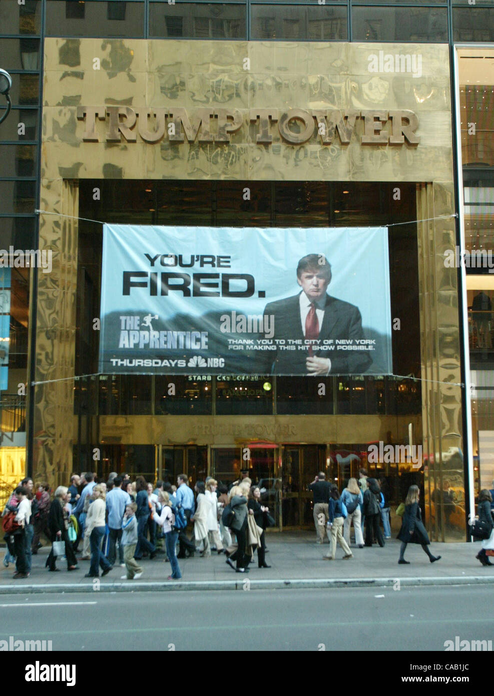 Mar 27, 2004; New York, NY, USA; A giant  Donald Trump  'You're Fired'  banner promoting the TV reality show 'The  Apprentice' hangs outside the Trump Tower. The sign is in  violation of zoning laws & has been issued 4 summonses that  could require a ,500 fine for each summons after a hearing.  Trum Stock Photo