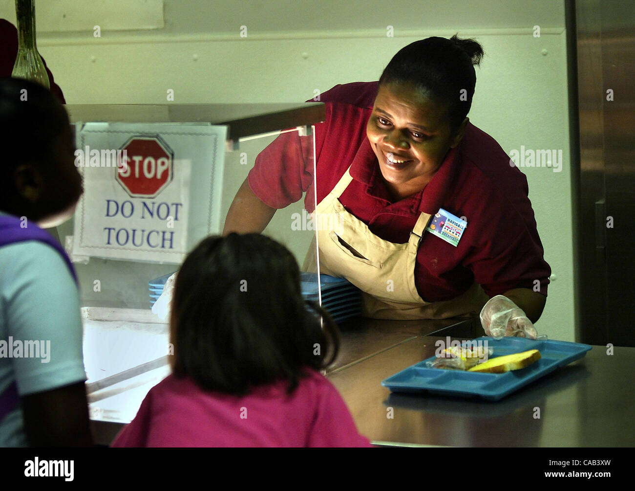 BELLE GLADE; 4/21/04 Melina Paul (cq) serves kiddies breakfast before