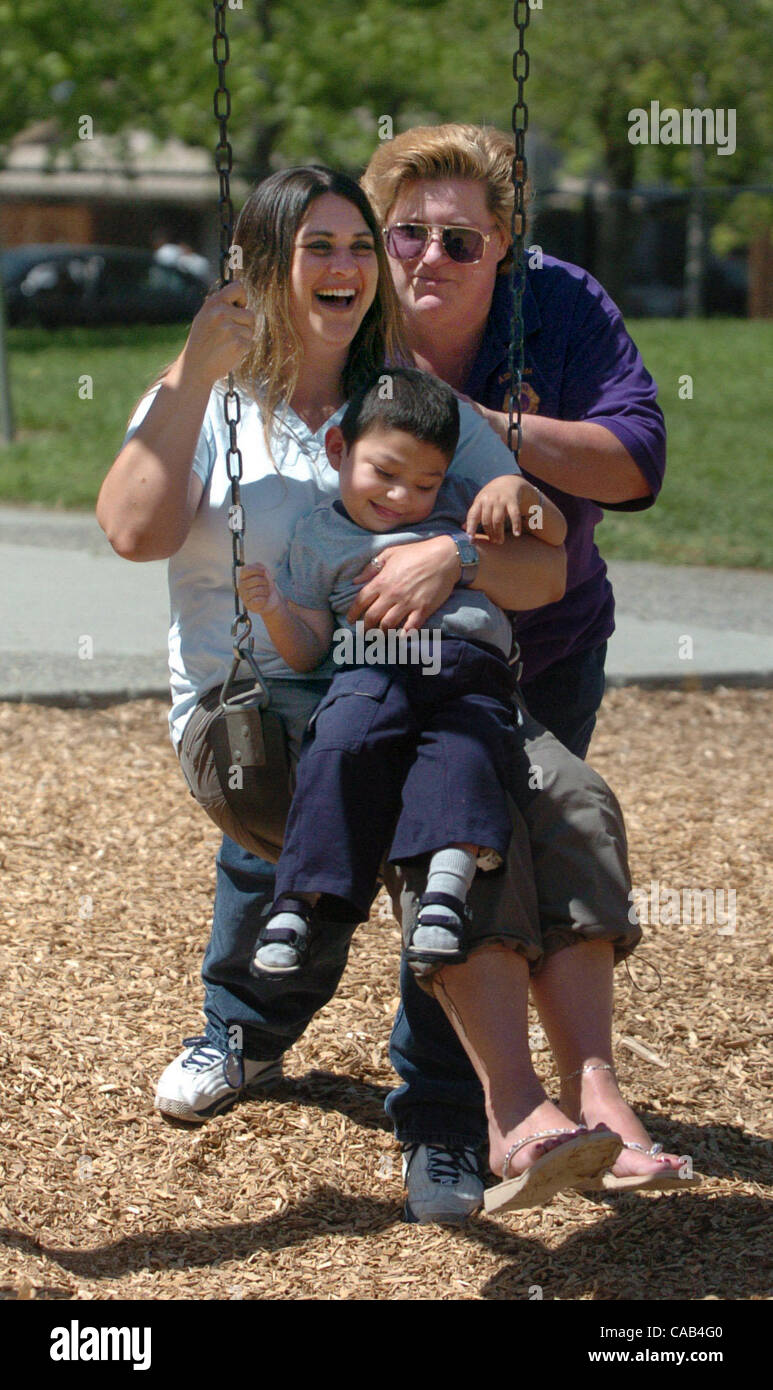 Liz Lamach pushes her disabled son Matteo, 4, and Matteo's aunt Monique Henderson on the swing during a trip April 7, 2004 to Hillcrest Park in Concord, Calif.   Lamach is spearheading an effort to create an 'all-abilities' park where disabled and fully-abled children can play together on the same e Stock Photo