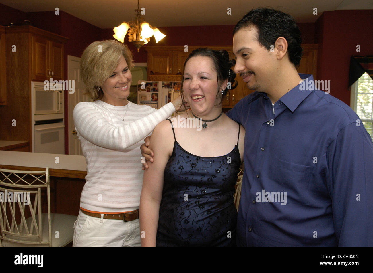 May 05, 2004; Woodstock, GA, USA; KIM RICHARDSON of Woodstock, adjusts her daughter KARISSA'S hair before she and her date SALOME DE SANTIAGO leave for Special Needs Prom.  Both Carissa and Salome are moderately intellectually disabled and are in the special education programs in the county schools. Stock Photo