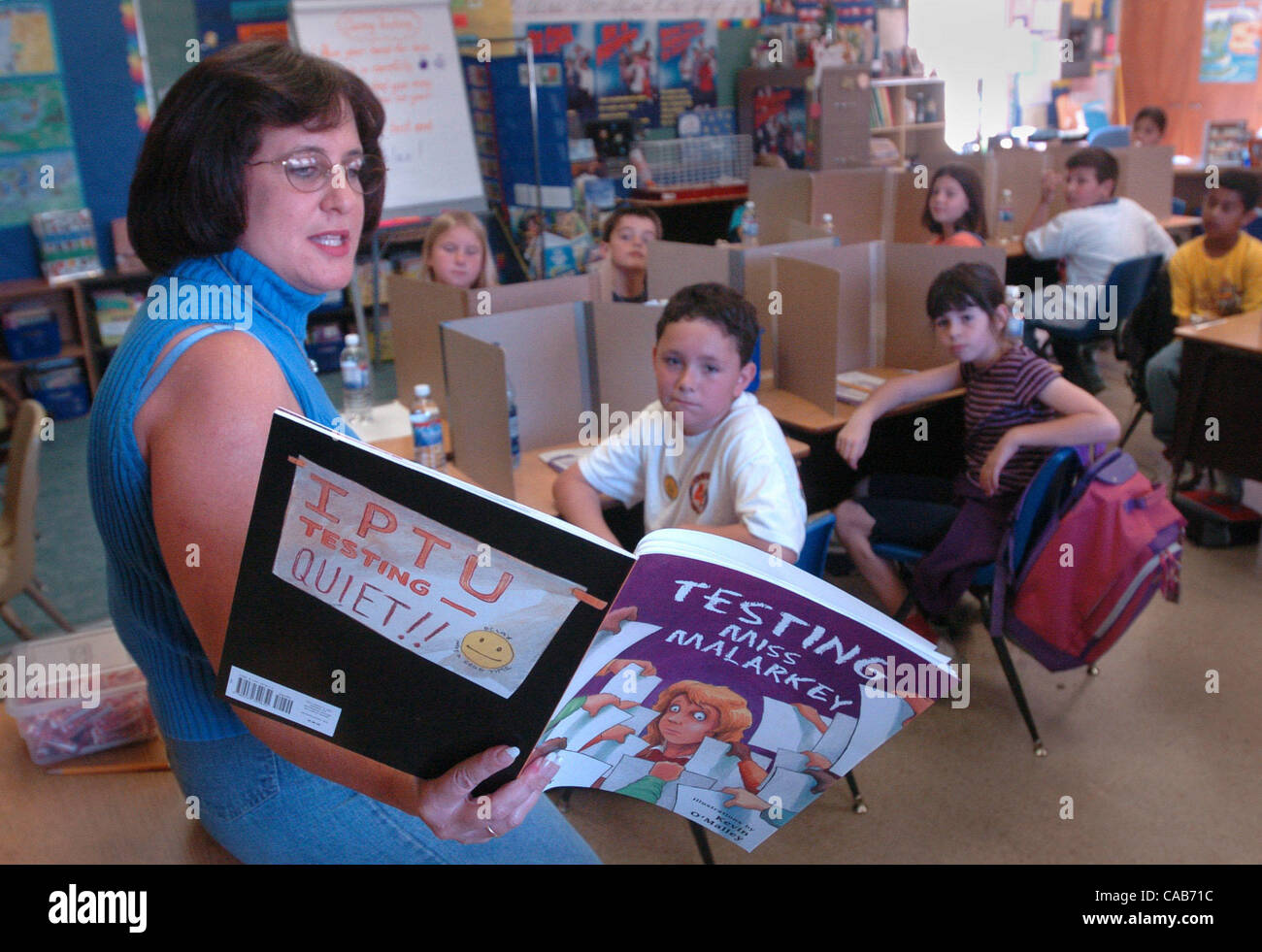 Teacher Laura Timmer reads a book about testtaking before her third