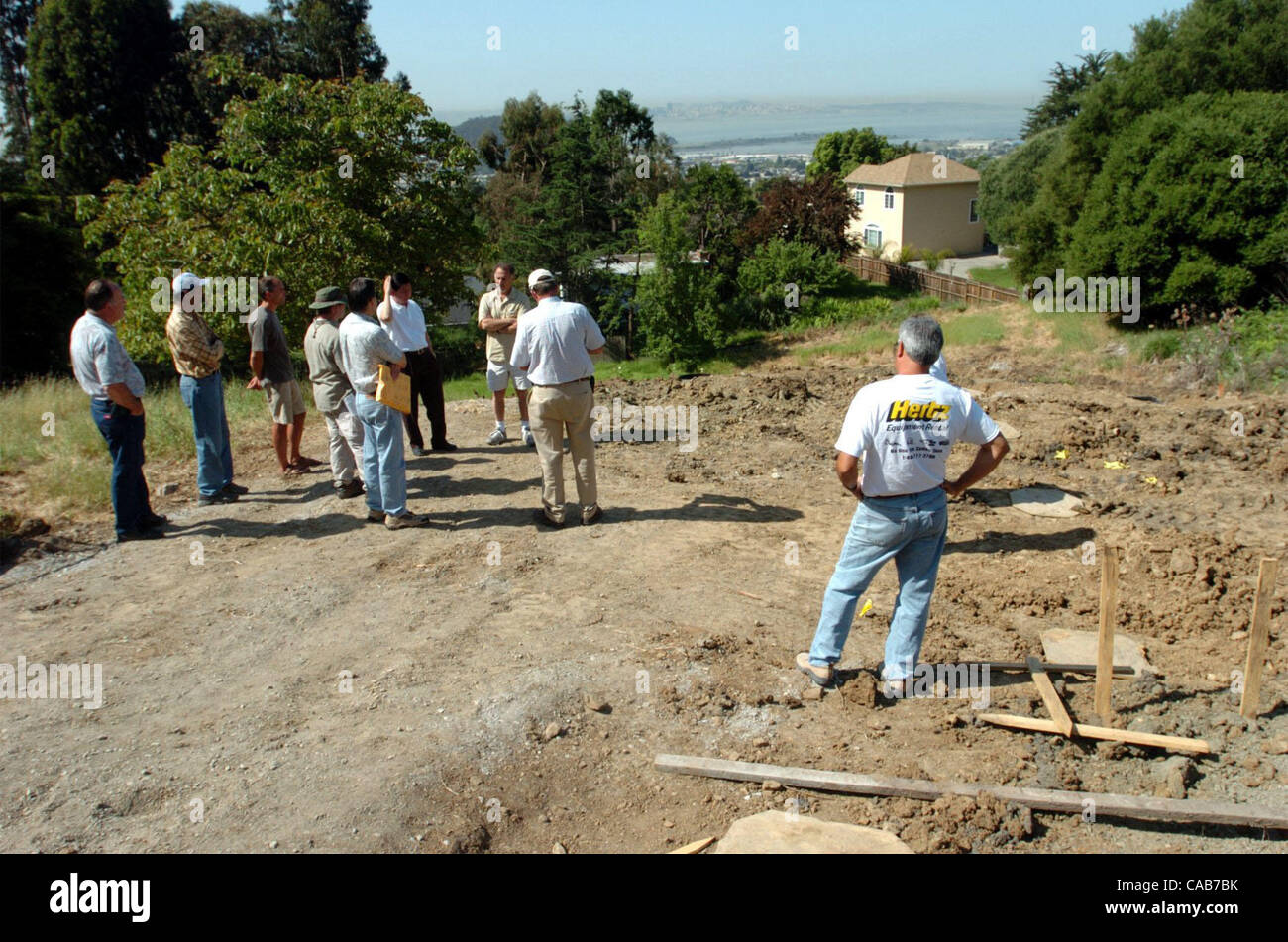 The city inspectors meet with Baljit Dhaliwal to see if the neighbors concerns about an ephemeral creek can be alleviated in the building of his residence on Tuesday April 27, 2004 in El Cerrito, Calif.   The construction has been stopped until a creek compromise could be reached.    (Contra Costa T Stock Photo