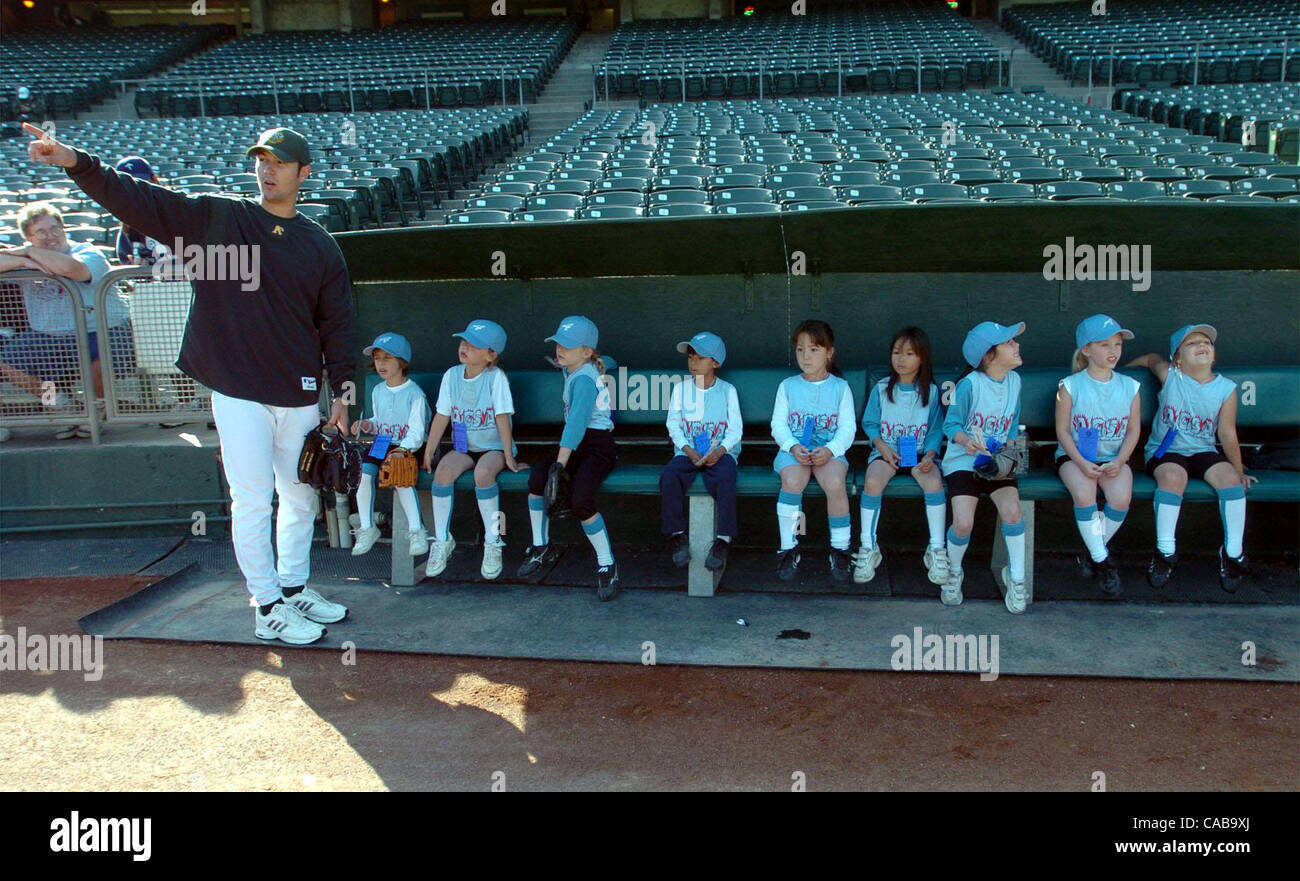 Pitcher Justin Duchscherer talks about baseball to the girls of Blue Angels softball team as they sit in the pitcher bullpen on Wednesday May19, 2004 in Oakland, Calif.   The team won a contest to learn a little about pitching from an Oakland A's pitcher.   (Contra Costa Times/ Gregory Urquiaga) Stock Photo