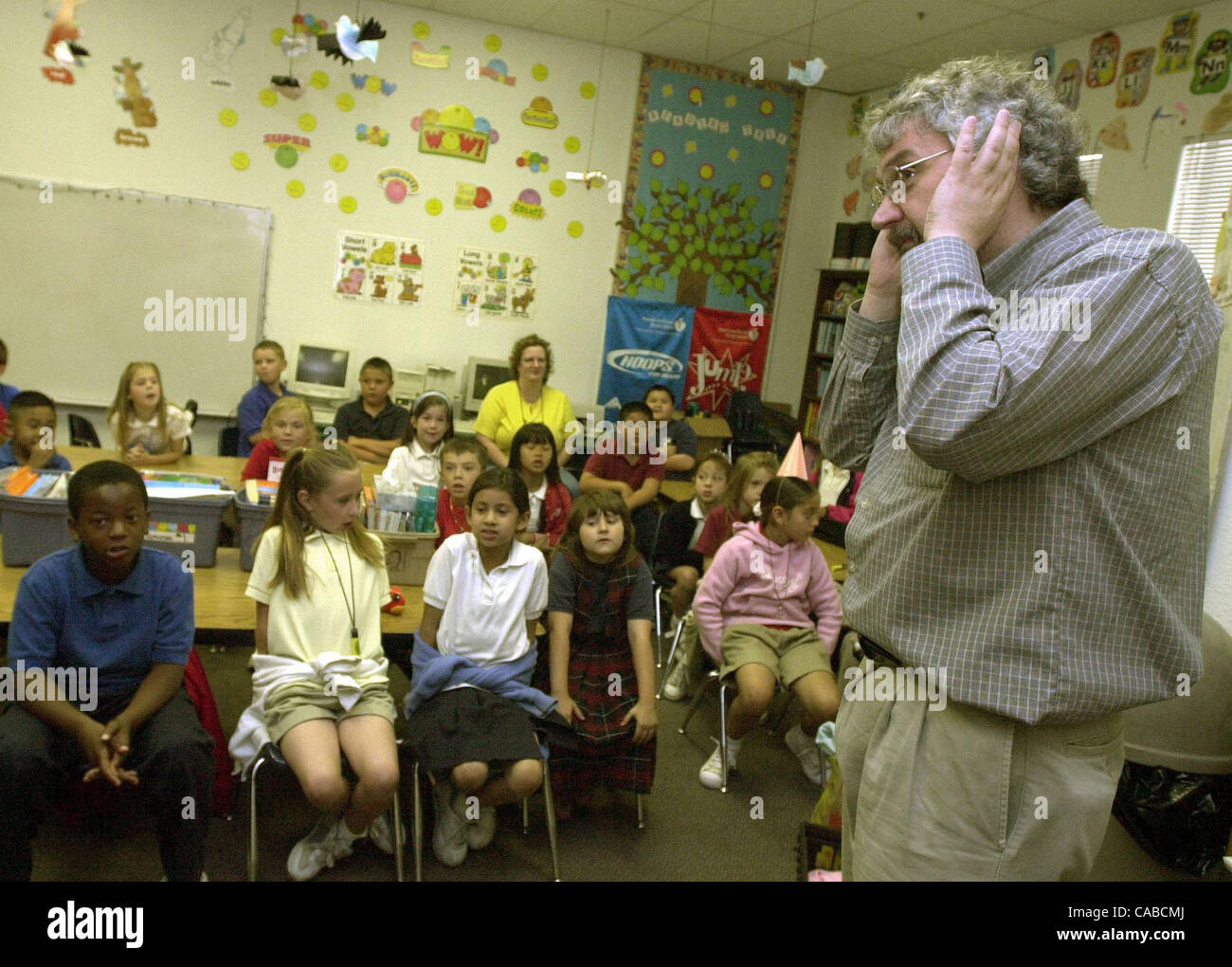 Playground designer, Dennis Wille, listens for input from first and second graders at the Calvary Temple Church in Concord, Calif. on Thursday, June 10, 2004.  The Ambrose Lions Club, together with Friends of Concord Parks and other organizations are preparing to build a playground at Hillcrest Park Stock Photo