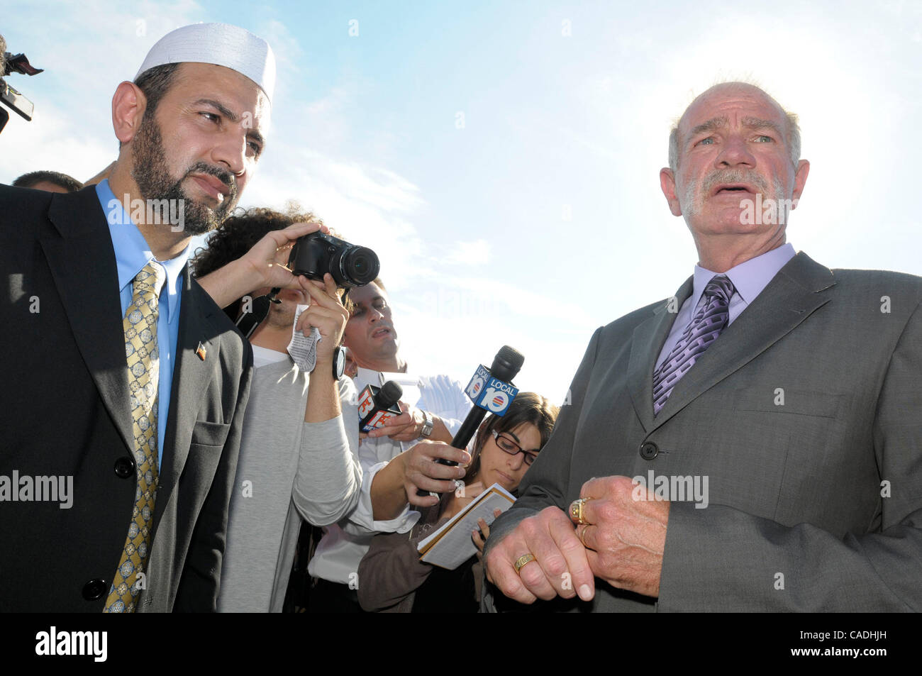 Rev. TERRY JONES, right, pastor of the Dove World Outreach Center, and Imam MUHAMMAD MUSRI, left, president of the Islamic Society of Central Florida, answer questions from reporters after announcing the cancellation of the planned Quran burning outside Jones's church. Rev. Terry Jones announced a c Stock Photo