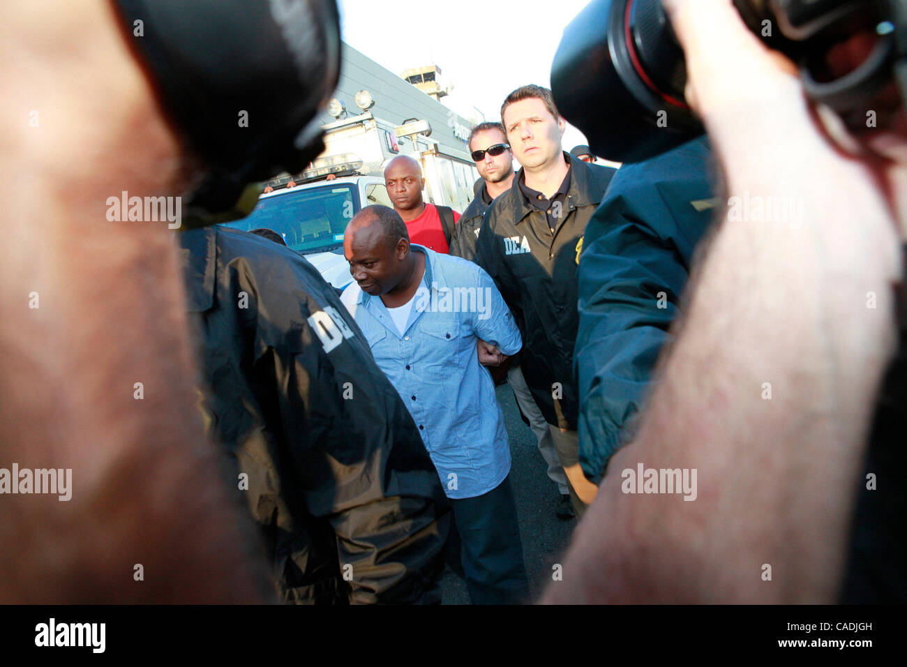 Jun 24, 2010 - White Plains, New York, USA - Jamaican gang leader and drug lord CHRISTOPHER 'DUDUS' COKE, 42, is escorted by DEA agents from the Avitat terminal at the Westchester County airport to a waiting vehicle. Coke arrived in the United States after being extradited from Jamaica to face drug  Stock Photo