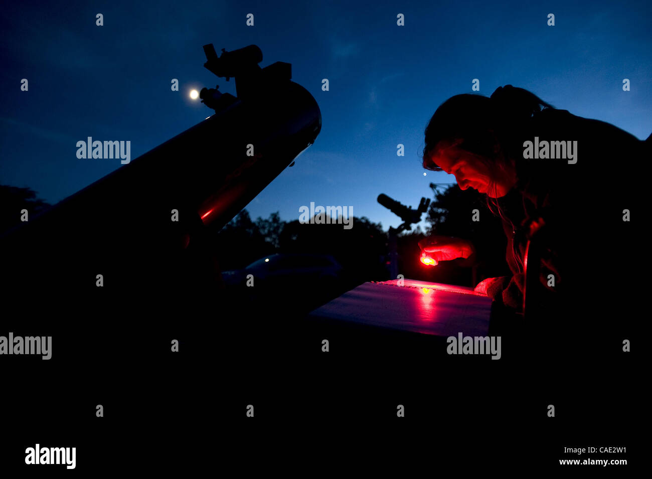 June 17, 2010 - Dexter, Michigan, U.S - Amy Cantu of Ann Arbor looks at a star chart next to her 8'' telescope at Peach Mountain near Dexter, Michigan in June of 2010. (Credit Image: © Mark Bialek/ZUMAPRESS.com) Stock Photo