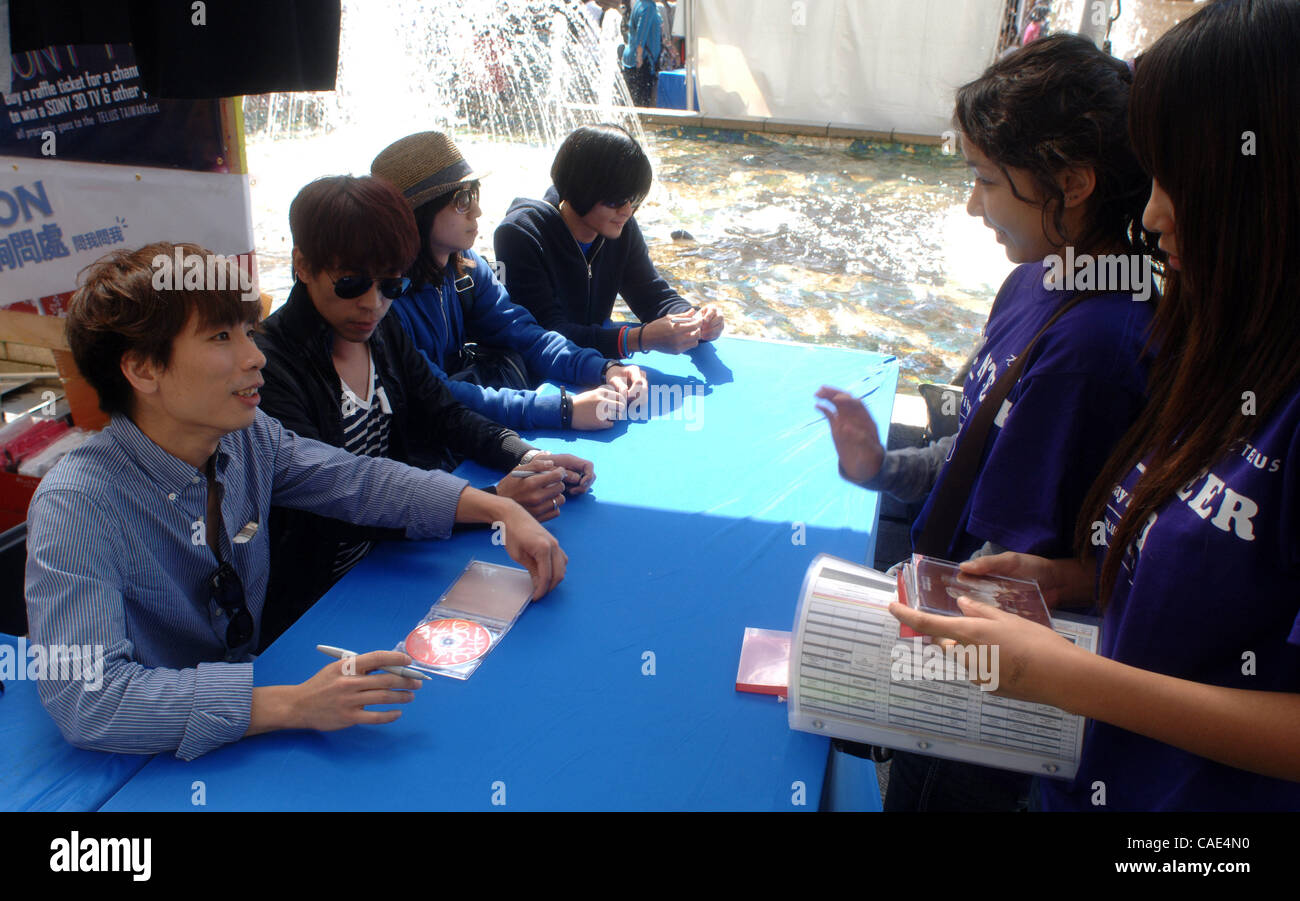Sep 05, 2010 - Vancouver, British Columbia, Canada - Members of Taiwanese band '1976' signing autographs after their performance at Telus TaiwanFest 2010 in Vancouver. Last spring, '1976' was invited as the opening guest for the Oasis Live Forever Tour in Taipei, the first Taiwanese band ever to per Stock Photo