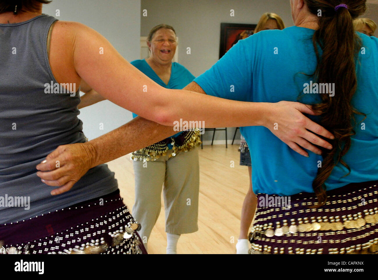 CAPTION: PHOTO 2:  (Hudson, 01/12/2008)  Kathy Bostick (center) is reflected in the mirror during Jackie Pearce's  beginning belly dancing class at Dancingly Yours on US Highway 19 in Hudson on Saturday, 1/12/08. For more information check their website www.dancingly-yours.com.  LANCE ARAM ROTHSTEIN Stock Photo