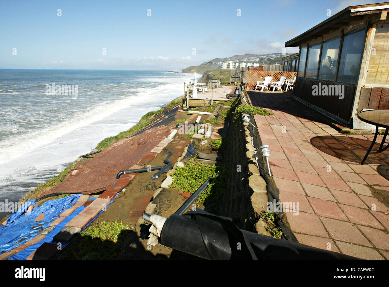 A house on Esplande Ave. in Pacifica, Calif., has tarps and drain pipes ...