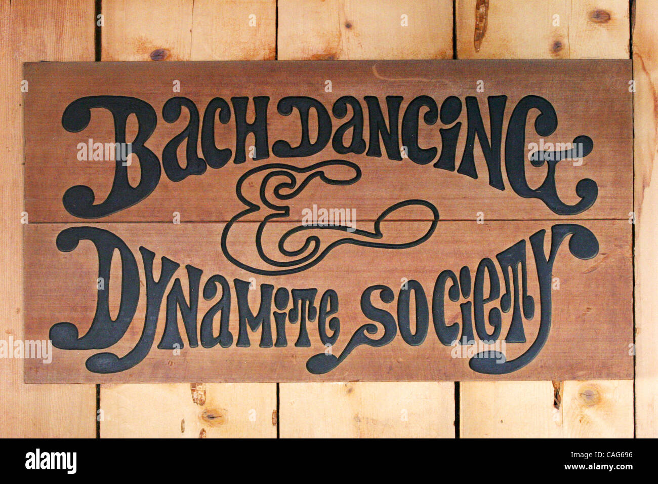 A sign for the Bach Dancing & Dynamite Society, hangs in a bar of the ...