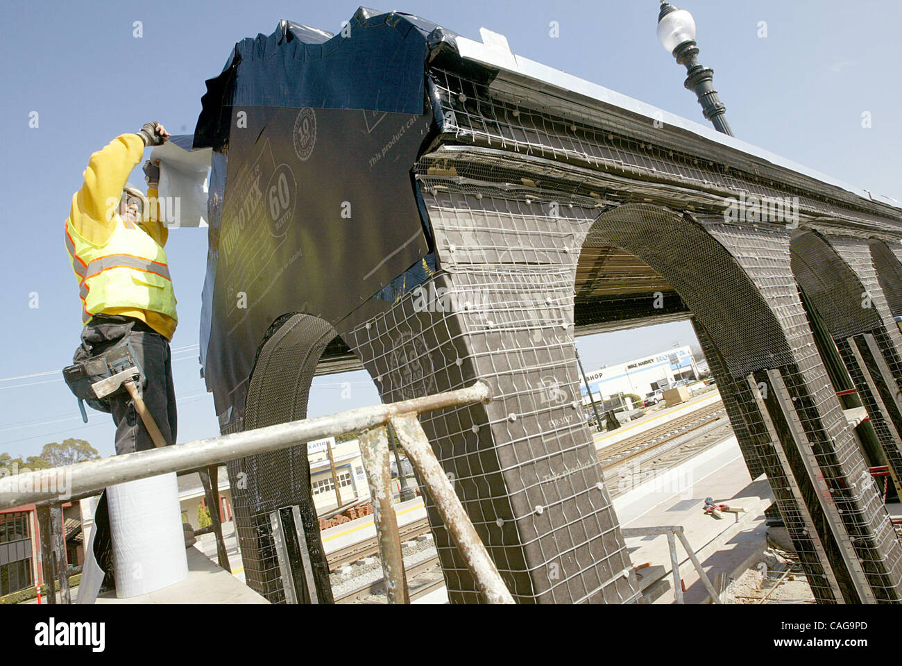 Isais Morales works on a new shelter at the train station in Burlingame ...