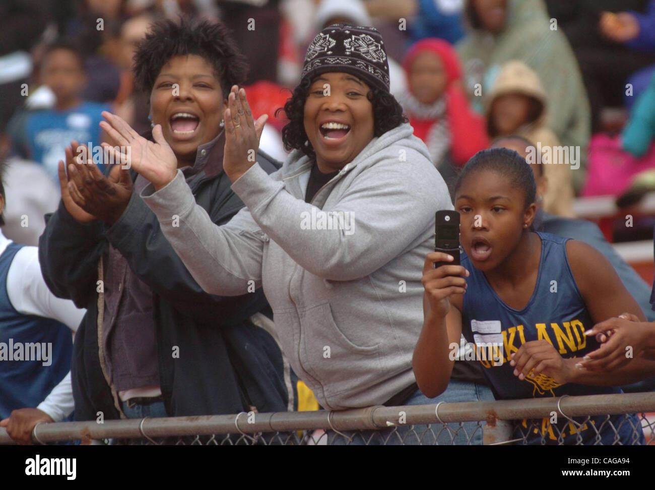 From left, Oakland residents Yoshika McAlister, Kim Franklin and her 13 year-old daughter, Kikia celebrate Morgan Franklins 1st place finish in the 50 yard-dash at the Eddie Hart Youth Track Meet in Pittsburg Calif., Sunday, April 6, 2008. A track and field meet for preschoolers to teens in honor of Stock Photo