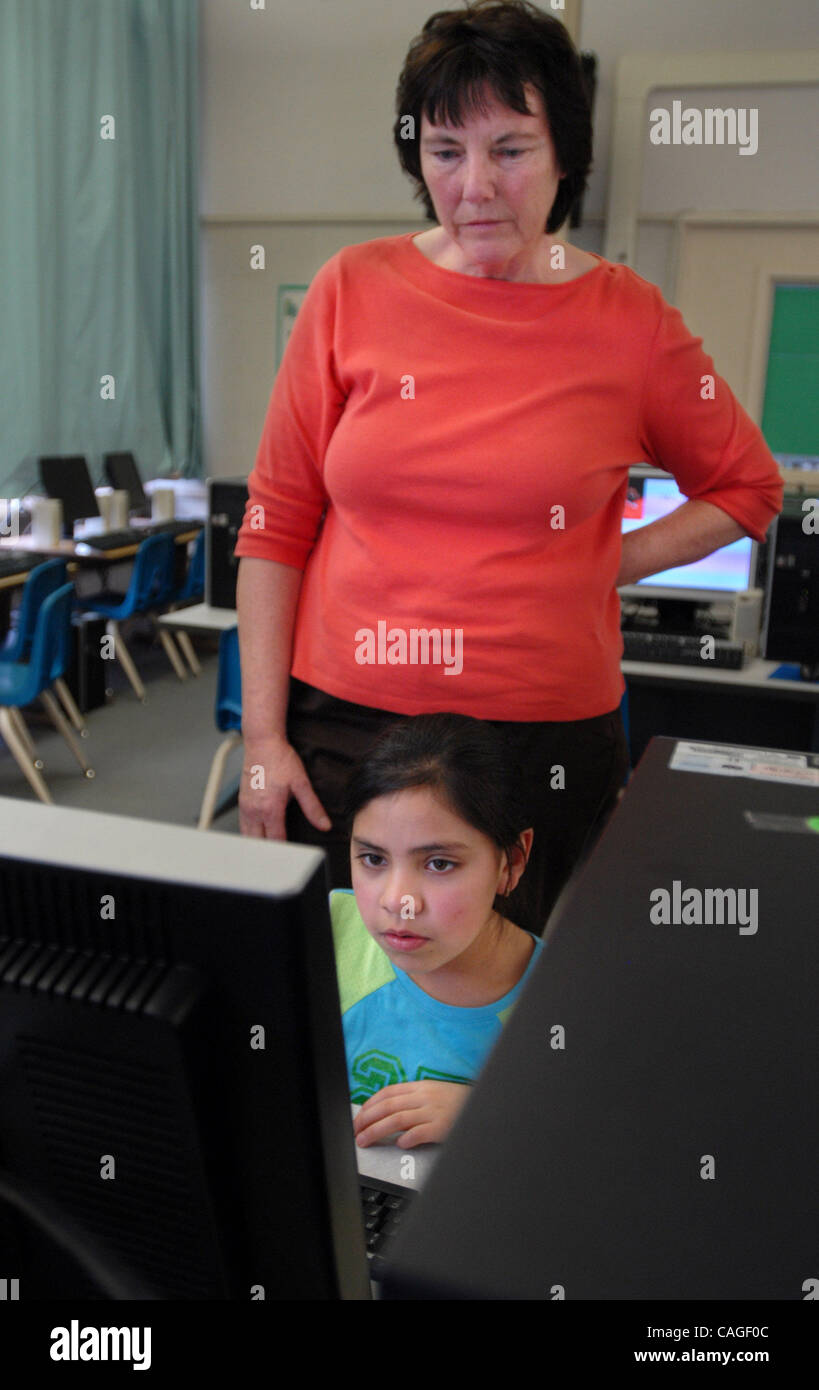Academic coach Karen Ruthnick helps third-grader Gina Moreno, who is part of the Intervention program, with a computer exercise afterschool at Holbrook Elementary School in Concord, Calif. on Thursday February 7, 2008. (Nader Khouri/Contra Costa Times) Stock Photo