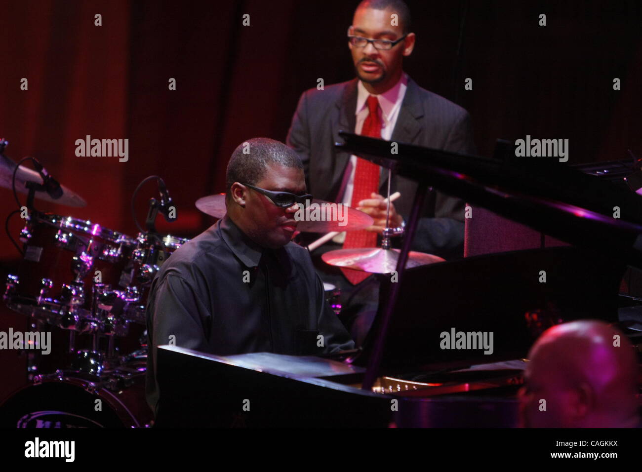 Marcus Roberts on piano performing 'Deep in the Shed- A Blues Sute' in The Allen Room at Jazz at Lincoln Center Time Warner Center on February 1, 2008.   Roland Guerin on Bass Jason Marsalis on drums Stock Photo