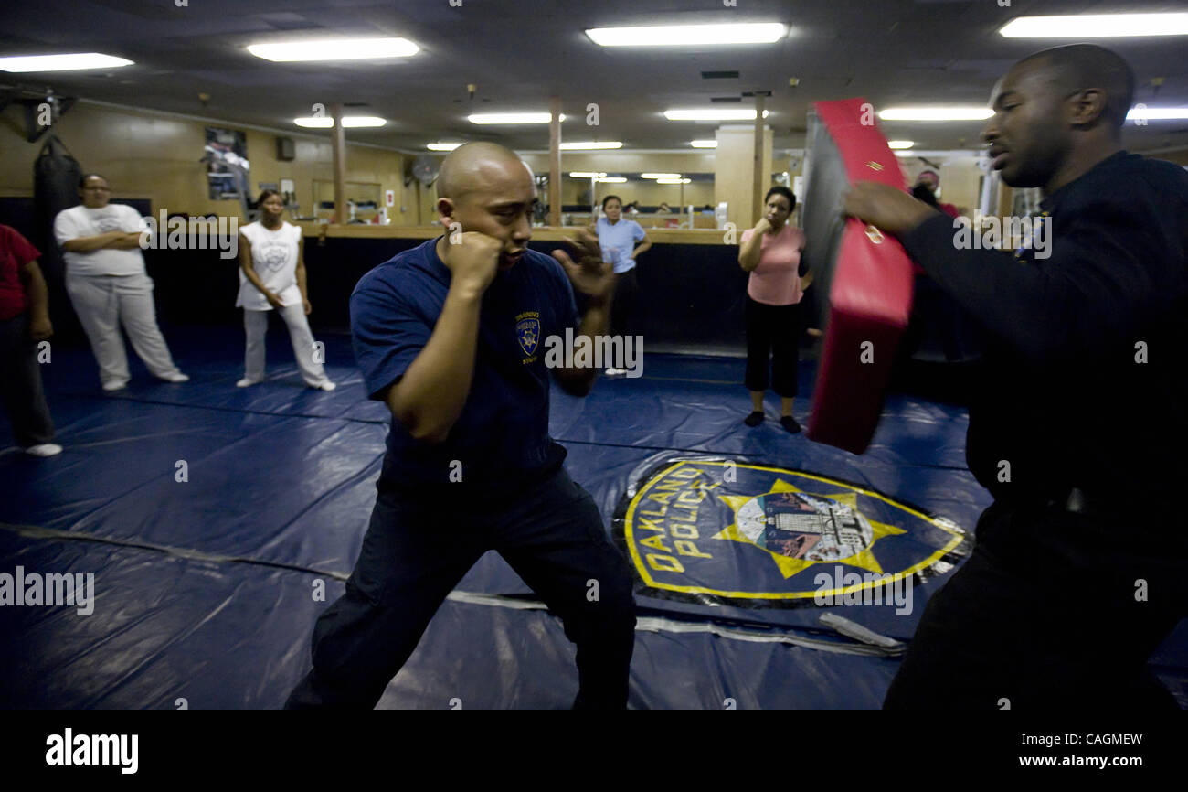 Saturday, February 2, 2008, Oakland Police Department officers Damon Gilbert, right, and Norman delRosario, center, show examples of how to fight during a self-defense class offered by the Police Department in Oakland, Calif.  (Alison Yin/Oakland Tribune) Stock Photo