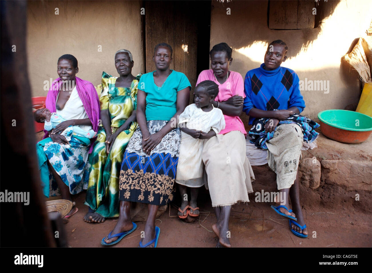 These distinctly tall and proud women are from the Acholi tribe in Northern Uganda. They have come to the islands with their families to find refuge from  Joseph Kony's rebels, the LRA. From left: Mama Agnes with Baby Agnes, Mijji Julanda (Grandma to Agnes), Mary (Mama Okello), Mama Onan, Rose ( a 1 Stock Photo