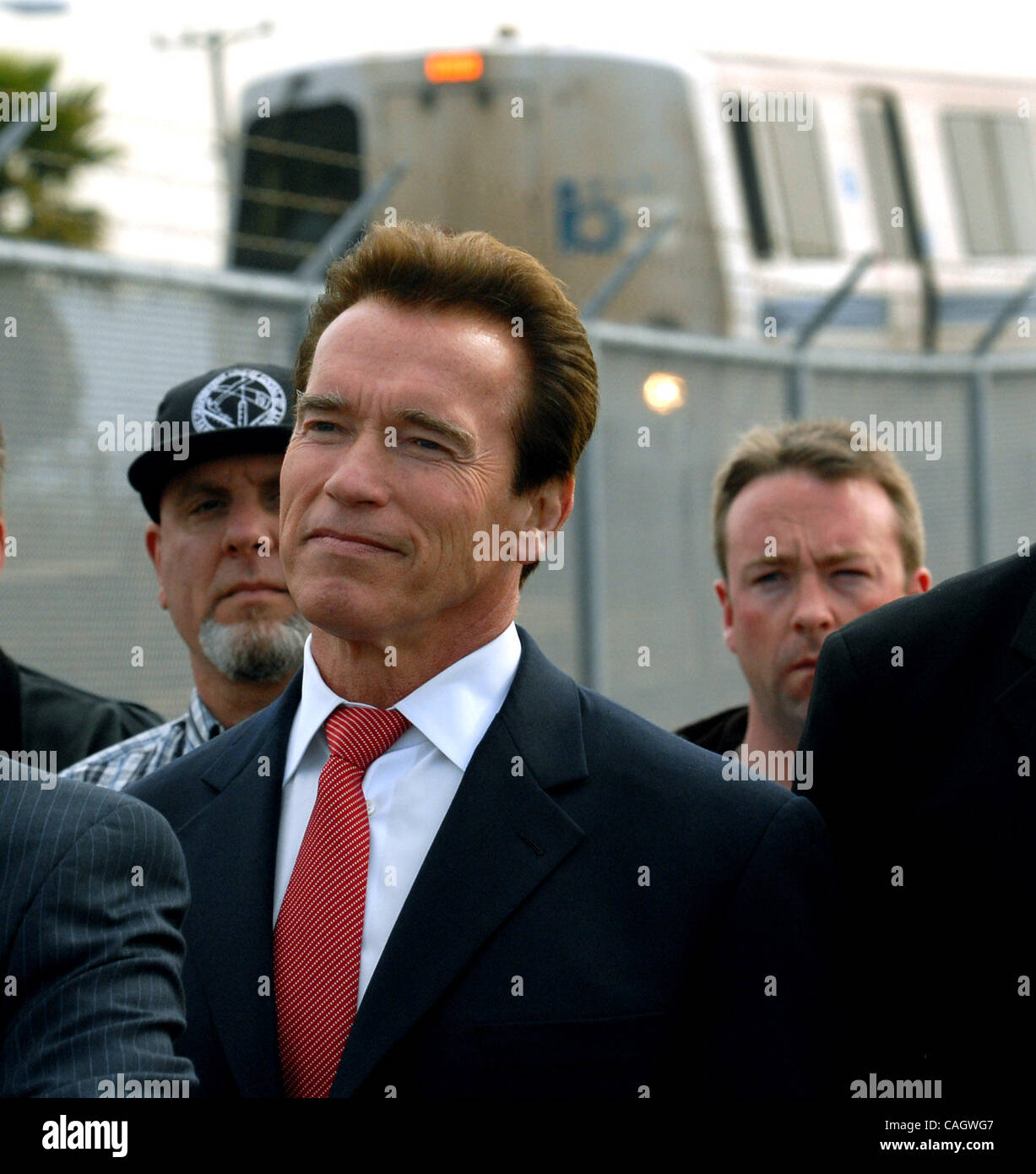 Governor Arnold Schwarzenegger listens during a press conference as a