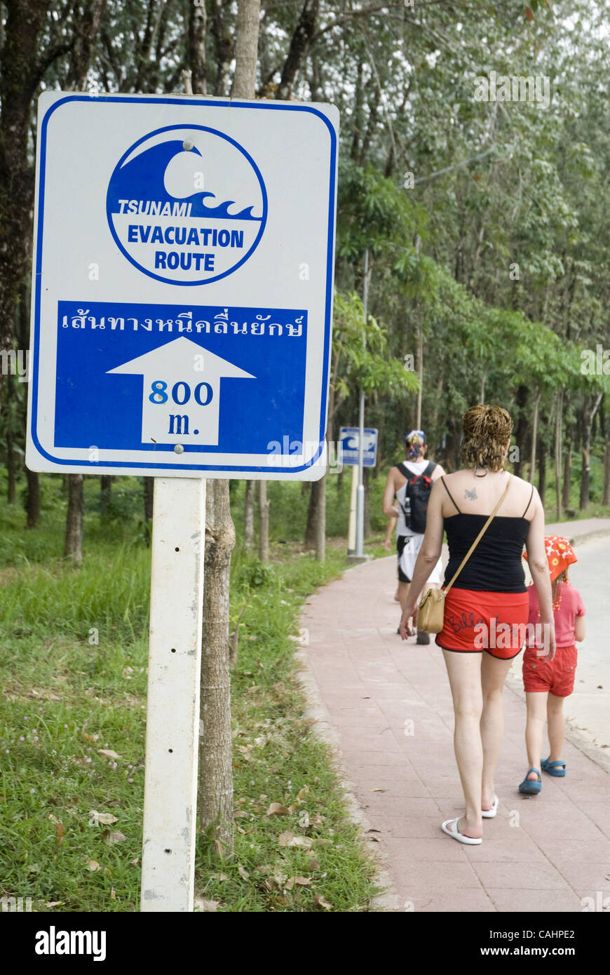 Signs warning locls and tourists about the tsunami hazzard ad evacuation routes. Khao Lak, Thailand. 12/12/2007  Three years after the devastating tsunami hit Southern Thailand the tourist trade is finally getting close to a full recovery.  Khao Lak area in Phang Nga Province was the most seriously  Stock Photo
