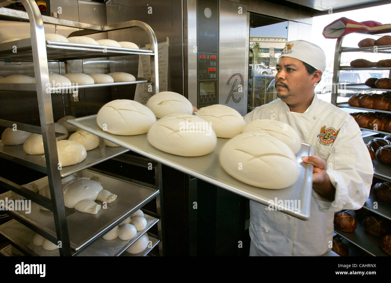December 14, 2007, San Marcos, California, USA Baker ANDREAS HERRERA places a tray of sourdough bread onto a rack at the new Boudin SF location going in at the Grand Plaza shopping center Mandatory Credit: photo by Charlie Neuman, San Diego Union-Tribune/Zuma Press. copyright 2007 San Diego Union-Tr Stock Photo
